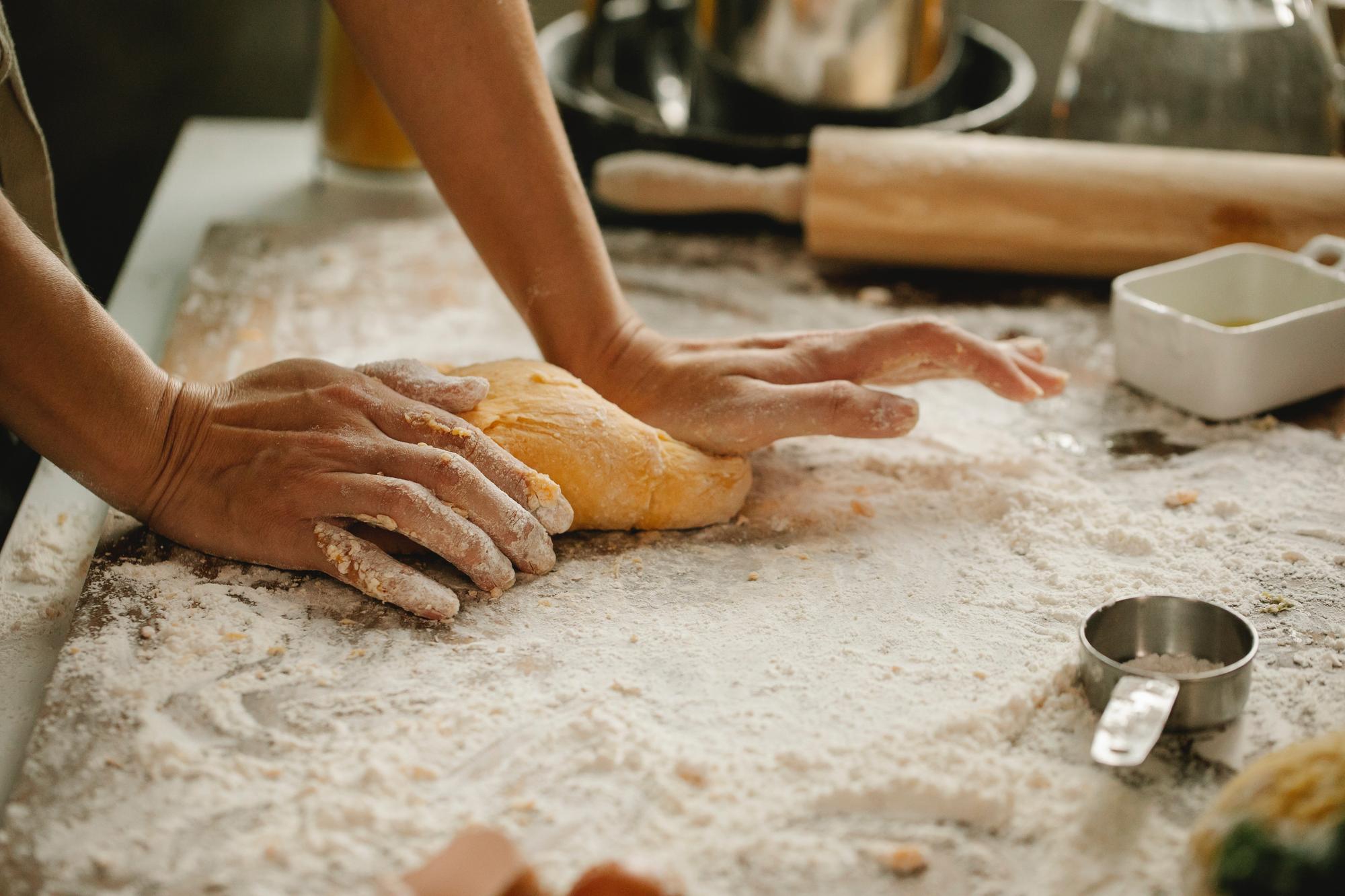 Close-up of hands shaping dough